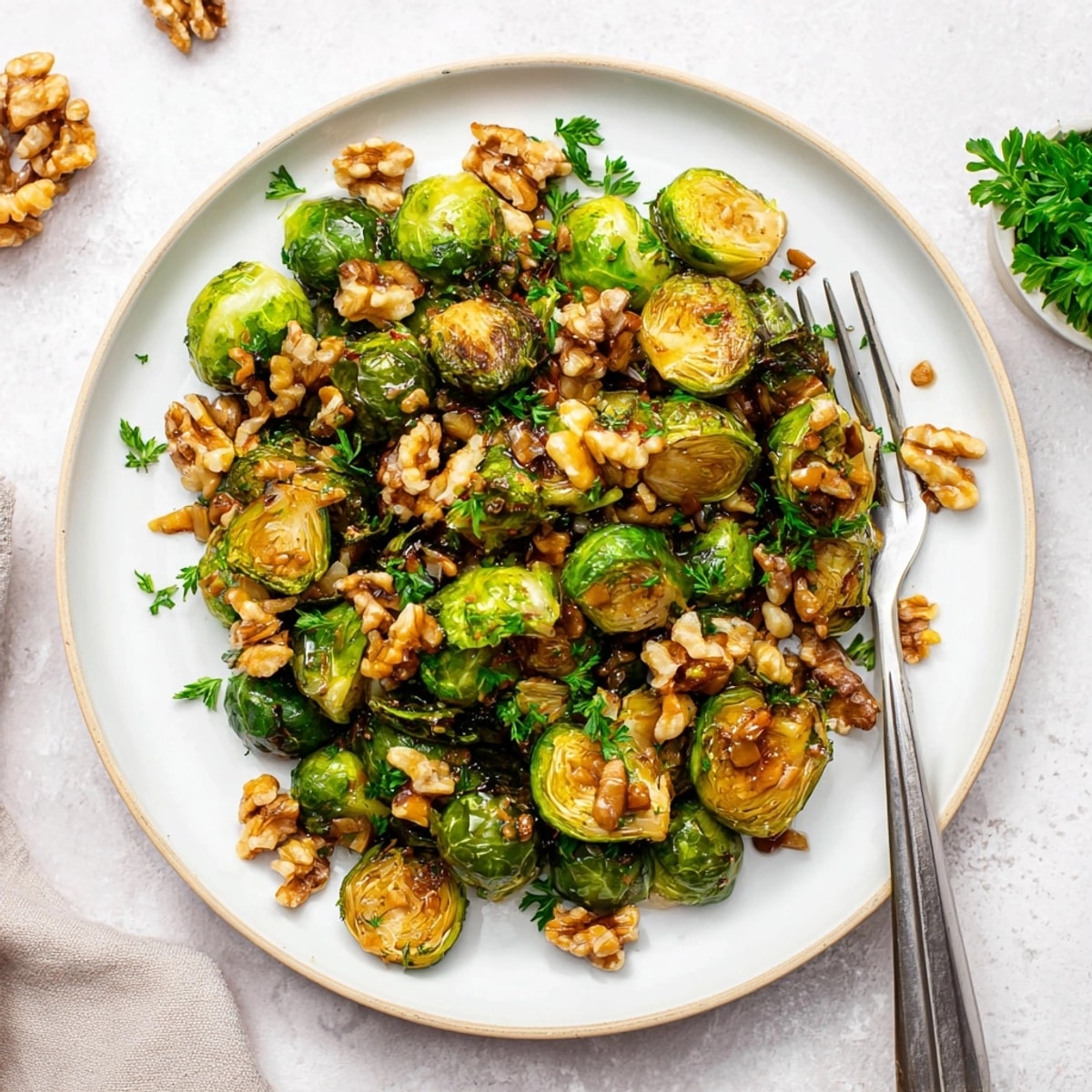 Enjoy warm, nutty Maple Glazed Brussels Sprouts with Walnuts – a simple, gluten-free side dish.
