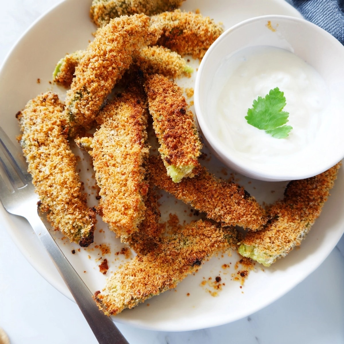 Plate of crispy Avocado Fries, ready for dipping in cool, creamy cilantro-lime sauce.