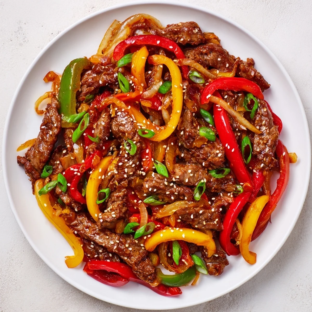 Savory Spicy Beef and Pepper Stir Fry with vibrant peppers and tender beef drizzled in sauce.