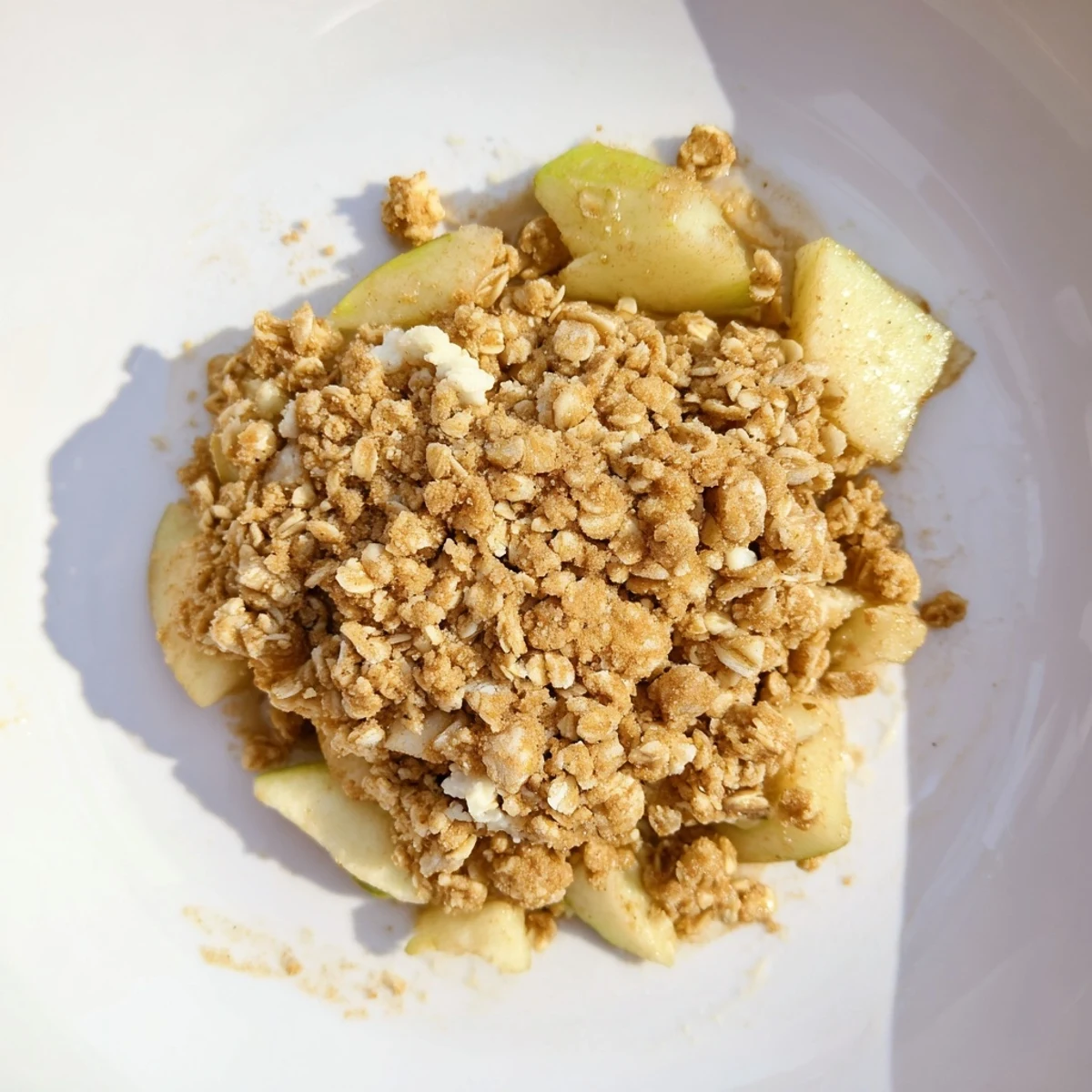 Homemade apple crumble: a comforting British dessert, served warm with vanilla ice cream.