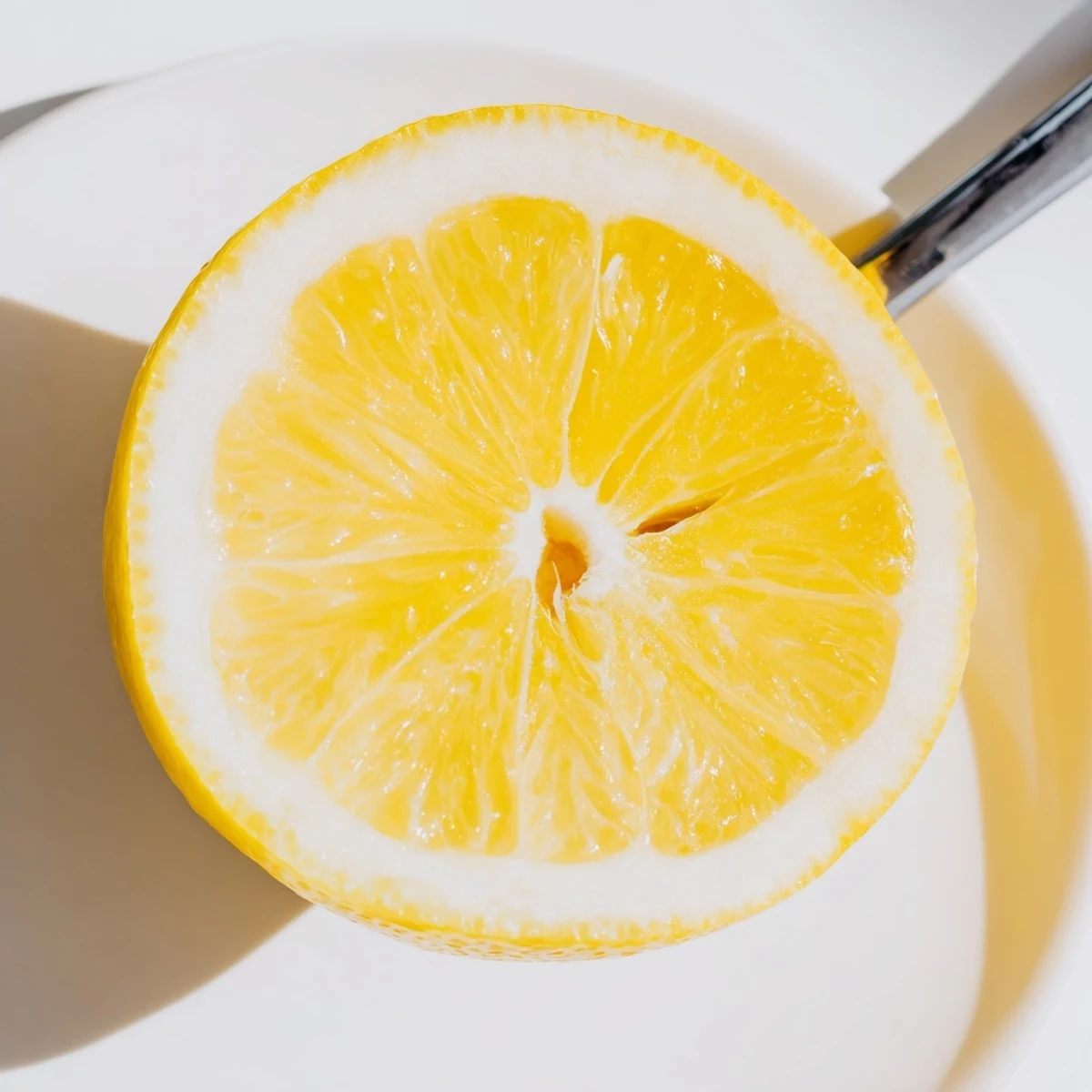 Fresh lemon wedge, ripe and bright, ready to squeeze for a burst of citrus flavor.