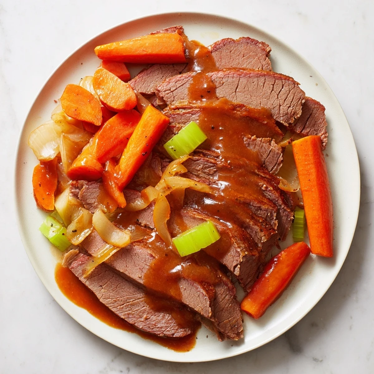 Tender Slow Cooked Beef Brisket, served with savory vegetables and rich, flavorful pan juices.