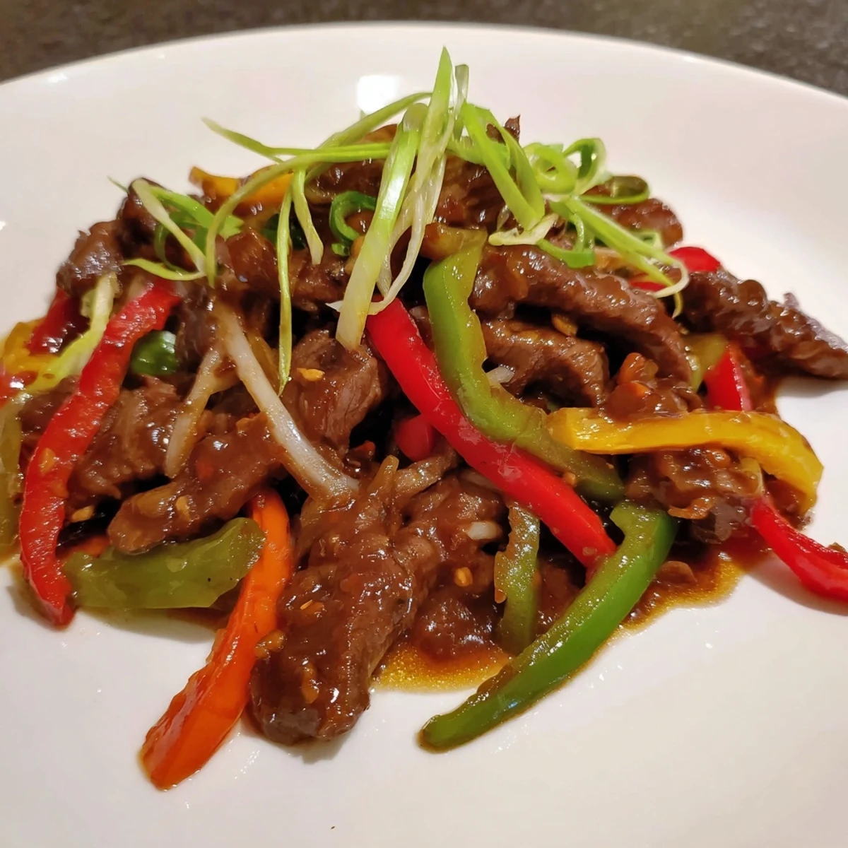A steaming bowl of Spicy Beef and Pepper Stir Fry, ready to serve over fluffy rice.