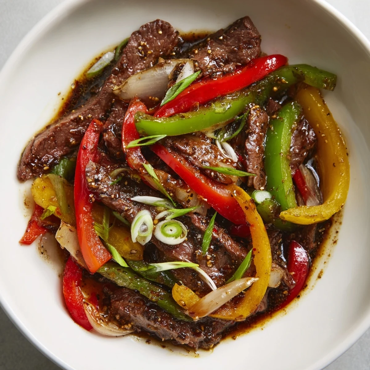 Sizzling Pepper Steak stir-fry, tender beef with colorful peppers in a rich, savory sauce, ready to serve.