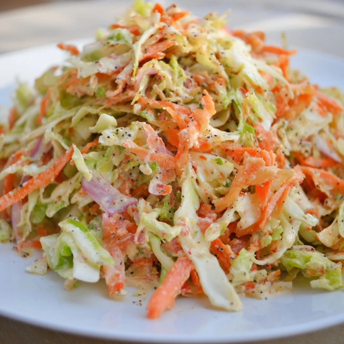 Vibrant and colorful Coleslaw, with a tangy dressing, makes a refreshing pairing for any meal.