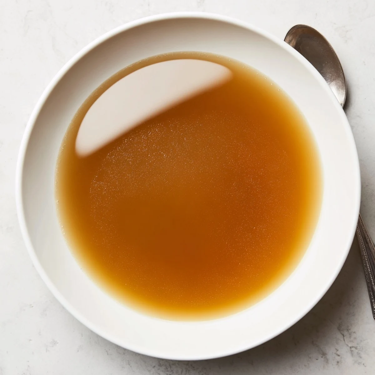 Aromatic photo of homemade classic beef stock, rich and deeply flavored, perfect for sauces.