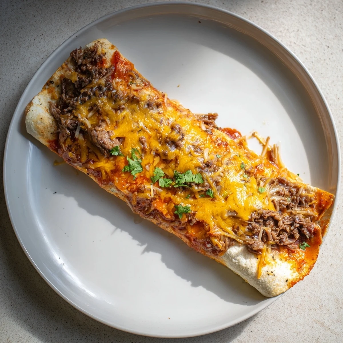 Golden, bubbly Beef Enchiladas, filled with savory beef and topped with melted cheese, ready to serve!
