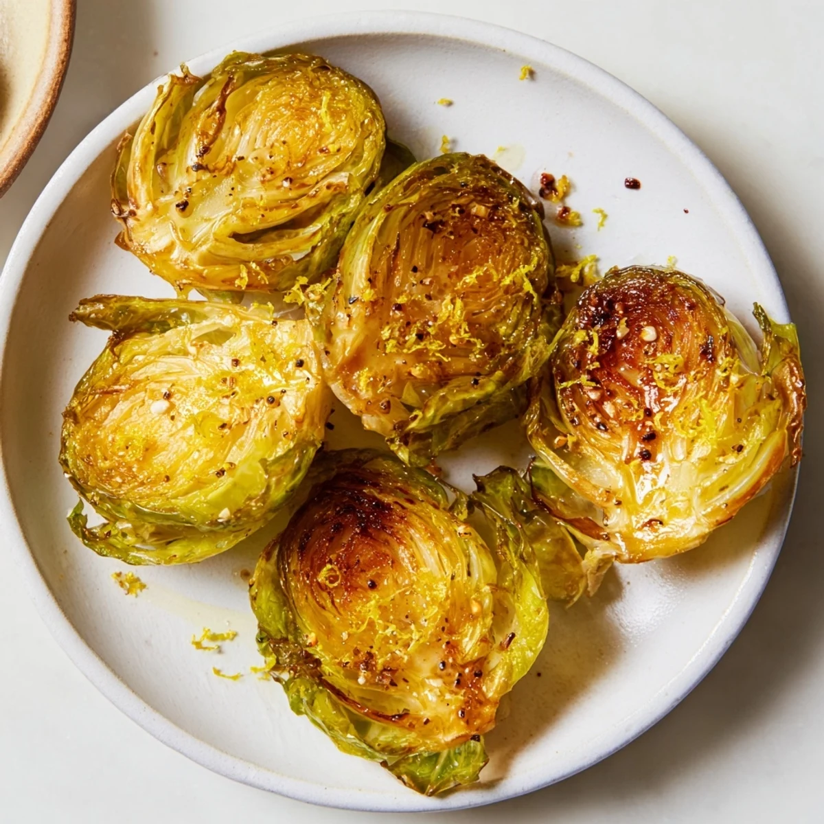 Close-up of caramelized Roasted Brussels Sprouts, their edges perfectly crisp, a delightful side.