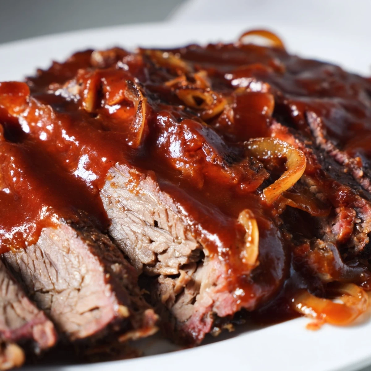 Slow Cooked Beef Brisket with BBQ Sauce resting on a wooden board, sliced to reveal tender, juicy meat and a dark, smoky bark.