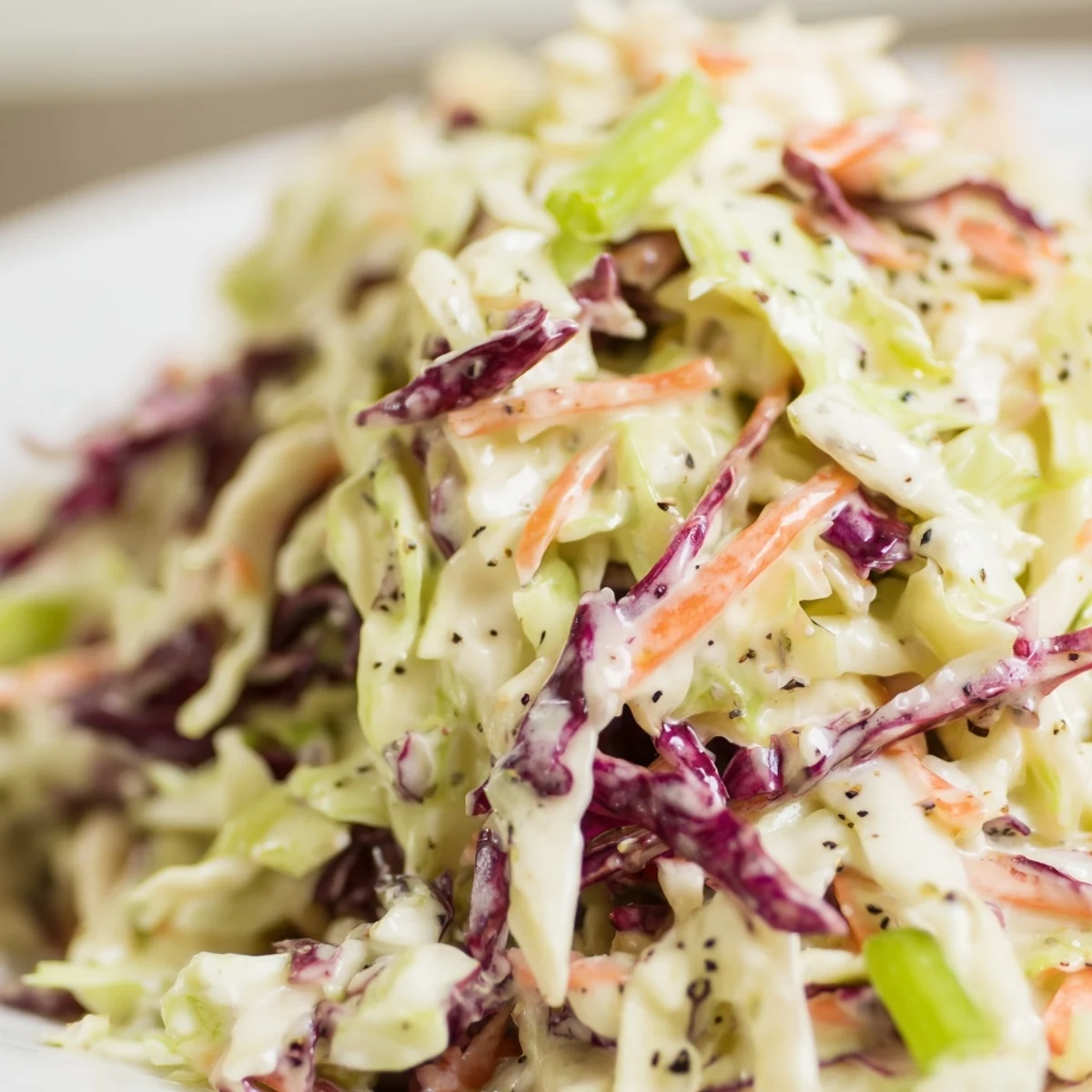 Bright, crunchy Creamy Coleslaw with Carrots tossed in a rich, tangy-sweet dressing for a backyard barbecue.