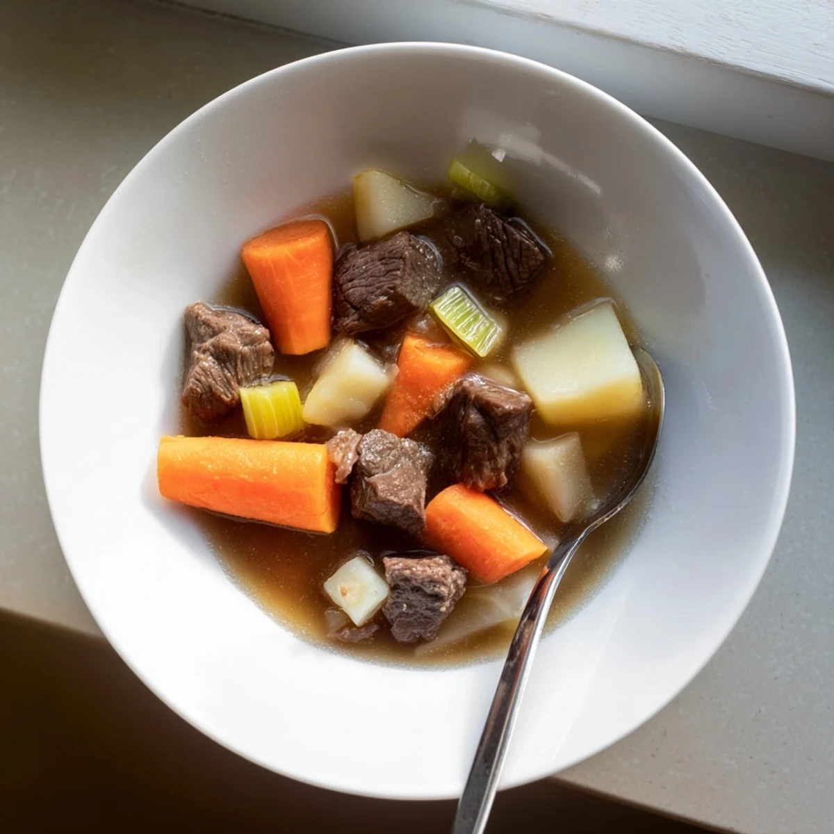 Slow cooker beef stew with root vegetables steaming in a rustic pot, with hearty chunks of beef, carrots, and russet potatoes ready to serve.