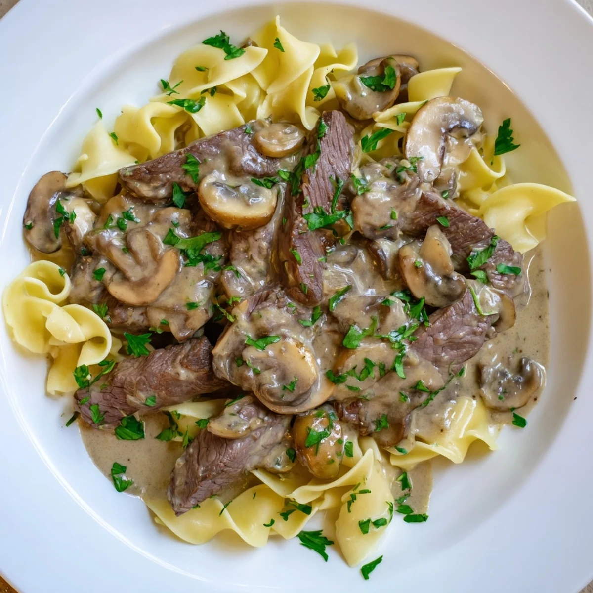 Tender beef strips and creamy mushroom sauce spooned over steaming egg noodles in this classic Beef Stroganoff.  