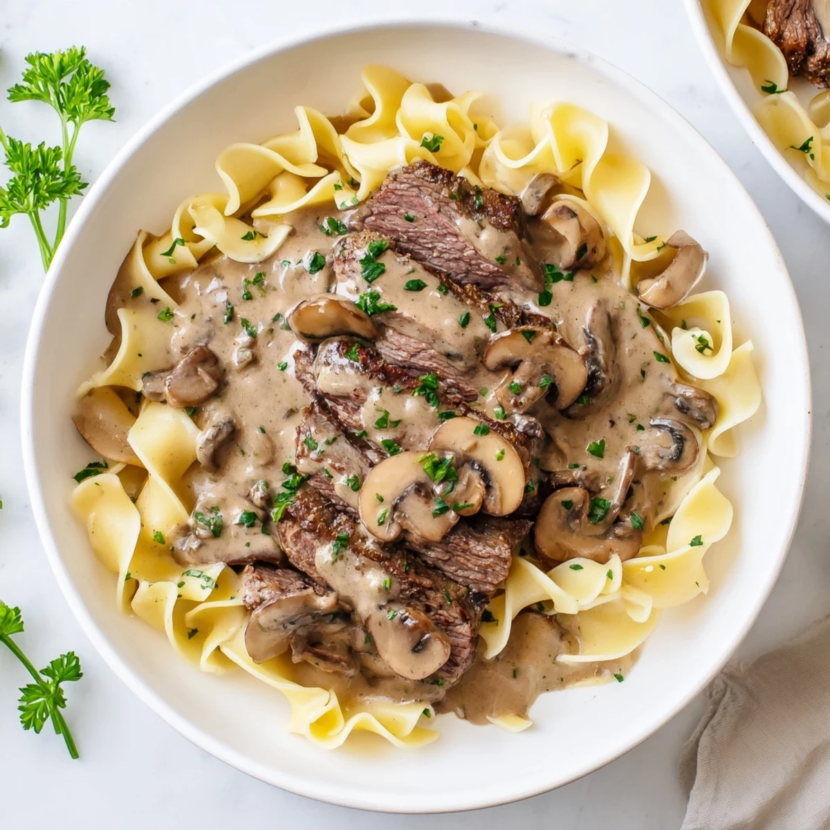 Golden brown beef and rich mushroom gravy coating wide egg noodles in a comforting Beef Stroganoff dish.