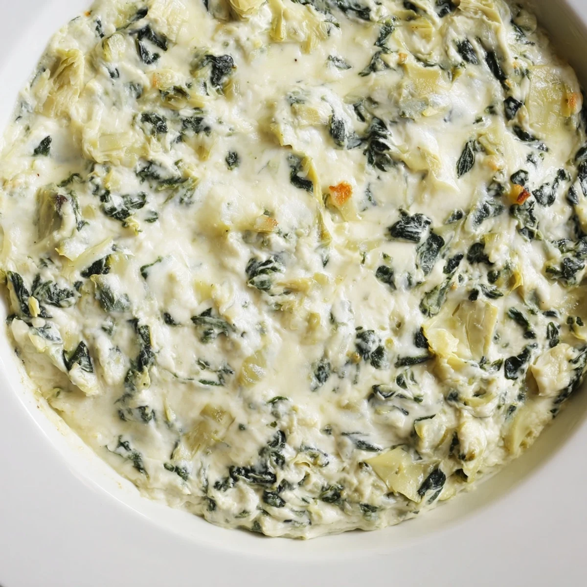 This easy, vegetarian appetizer features rich cream cheese, tender spinach, and savory artichokes for a crowd-pleasing bite.  