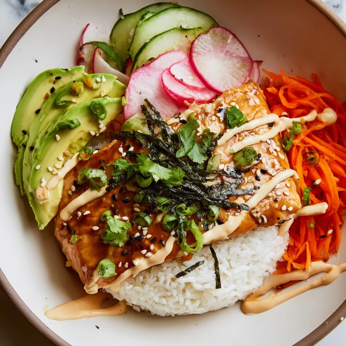 Flaky teriyaki salmon sits atop fluffy jasmine rice with crunchy pickled veggies and creamy sriracha mayo.