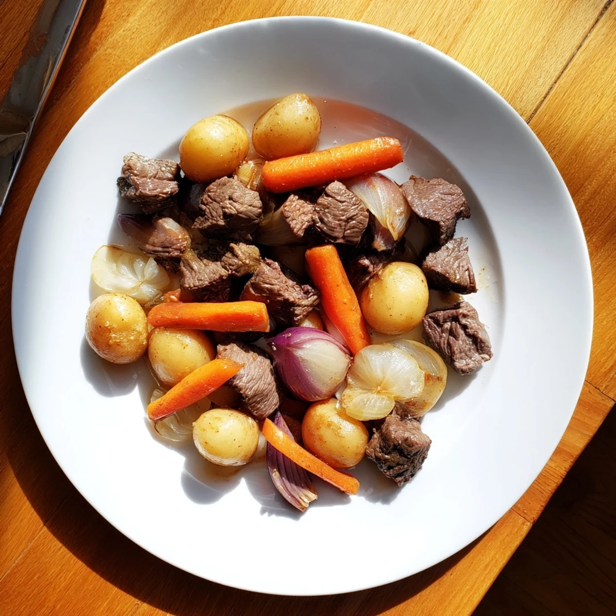Golden beef cubes and halved baby potatoes glisten in rich garlic butter sauce in Slow Cooker Garlic Butter Beef with Potatoes, topped with fresh parsley.