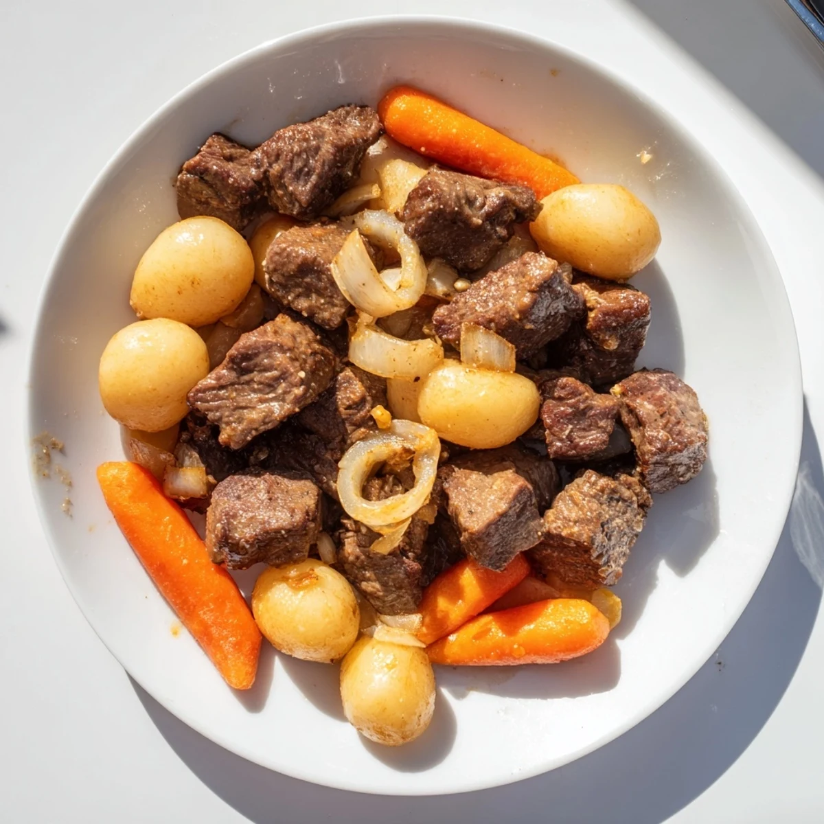 This Slow Cooker Garlic Butter Beef with Potatoes features fork-tender beef and carrots in a savory, herb-scented gravy, served steaming from the slow cooker.