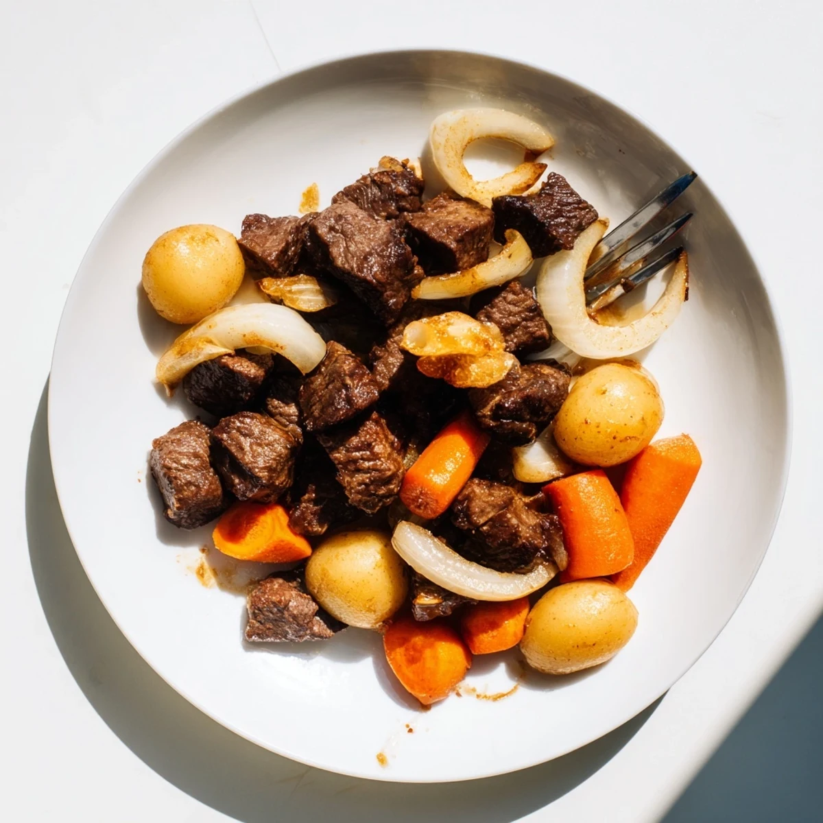 Slow Cooker Garlic Butter Beef with Potatoes offers a comforting, gluten-free main dish, with saucy chunks of beef and potatoes alongside crusty bread for dipping.