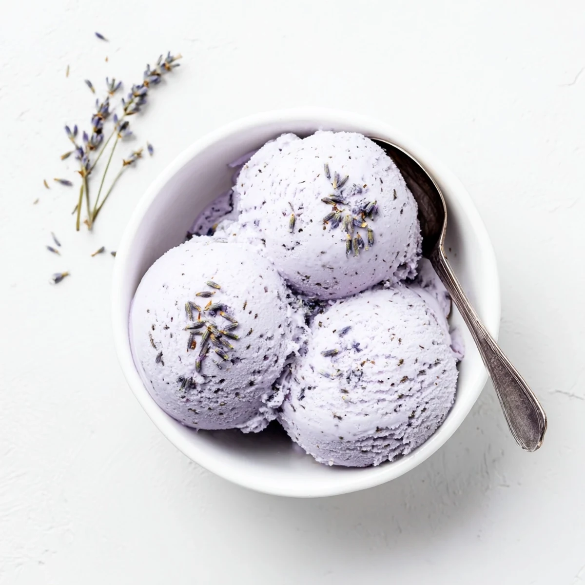 This homemade Lavender ice cream scoops beautifully from a chilled container, perfect for an elegant French dessert or refreshing summer treat.