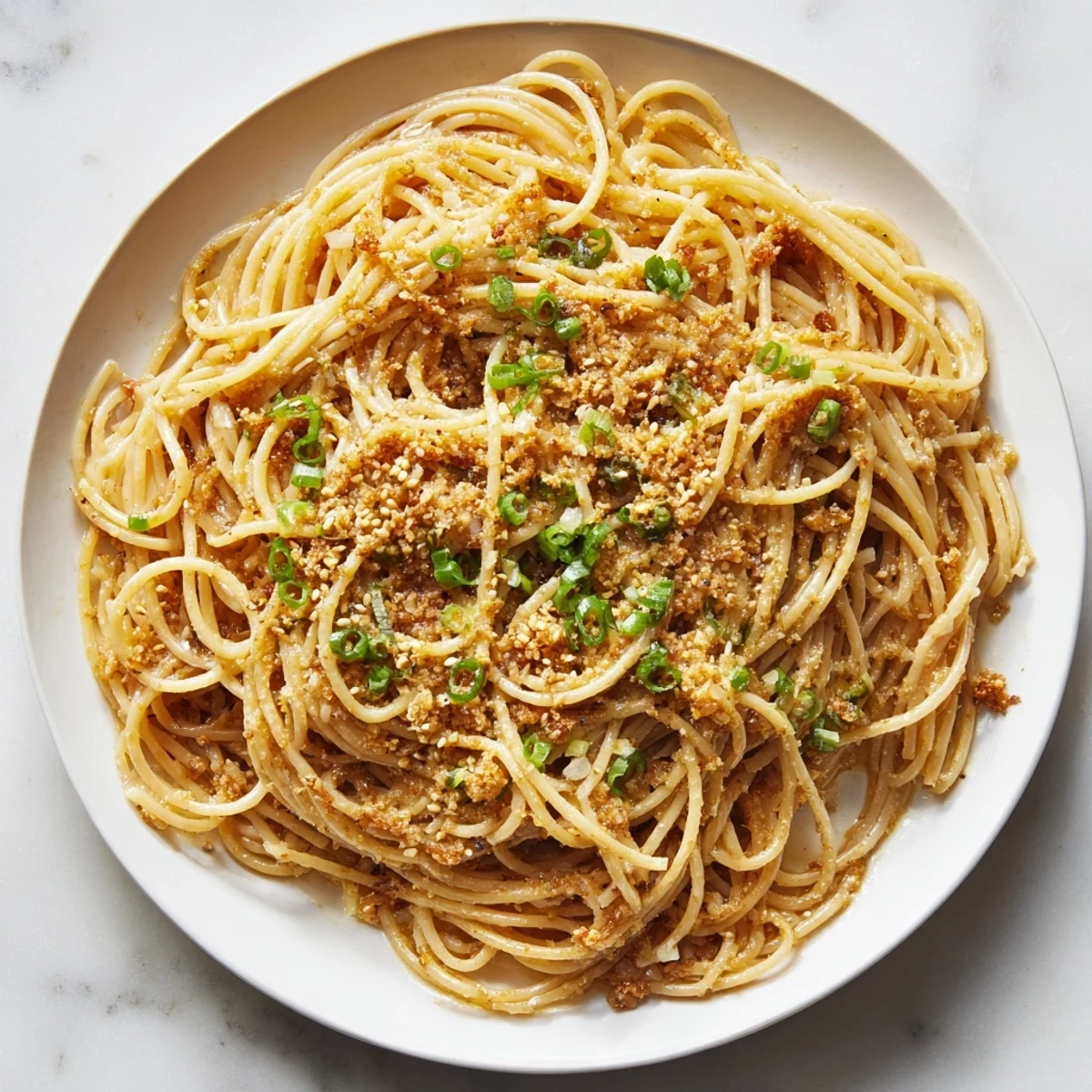 Garlic Noodles tossed in a glossy, savory sauce, served hot and ready to enjoy alongside a crisp green salad.