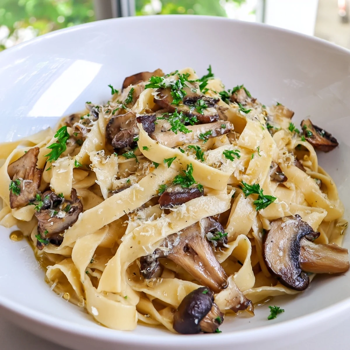 Creamy Truffle Mushroom Pasta twirls in rich sauce with golden sautéed mushrooms on a romantic plate.
