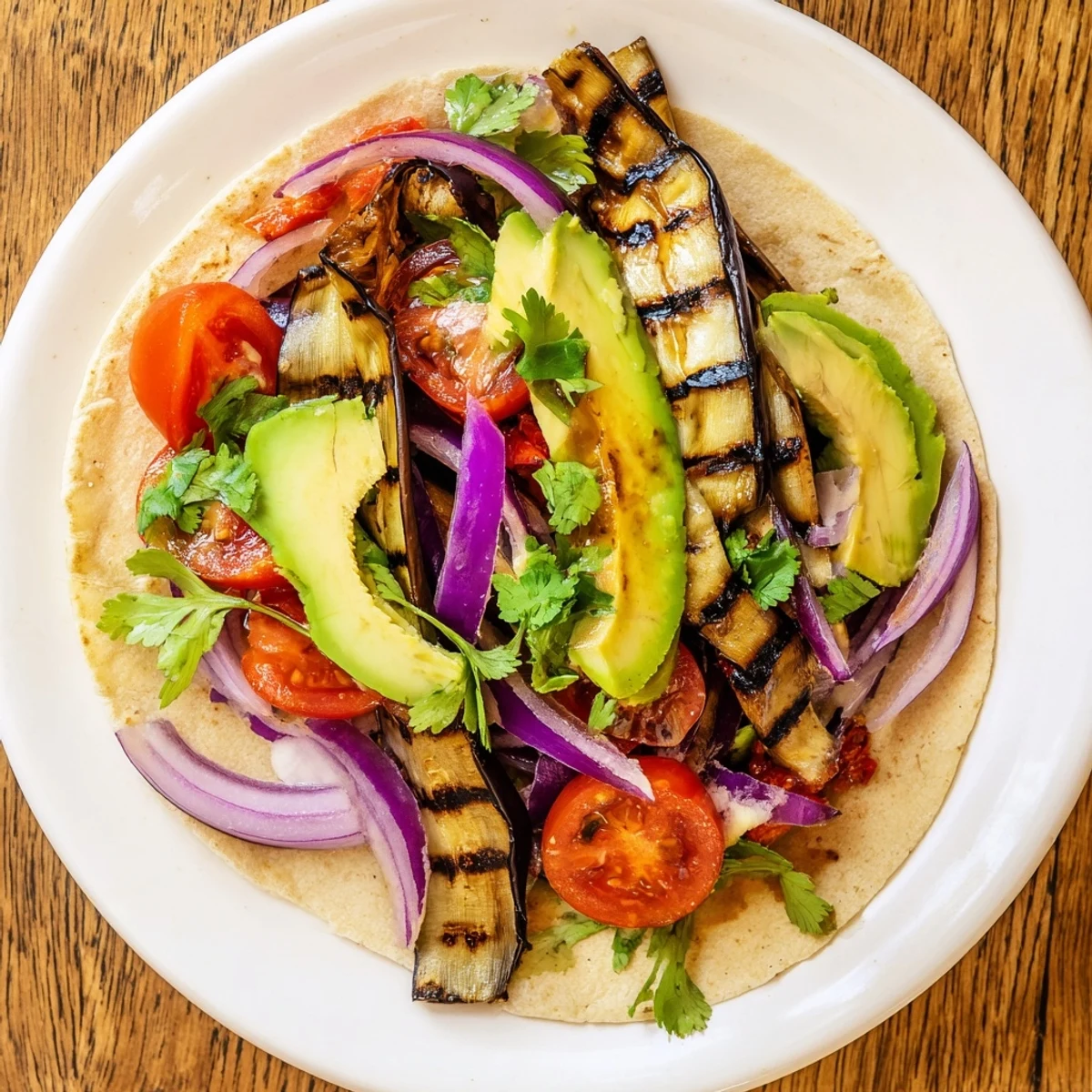 Hearty Charred Eggplant Tacos with char-marked eggplant, red onions, and vibrant toppings on a rustic wooden board.
