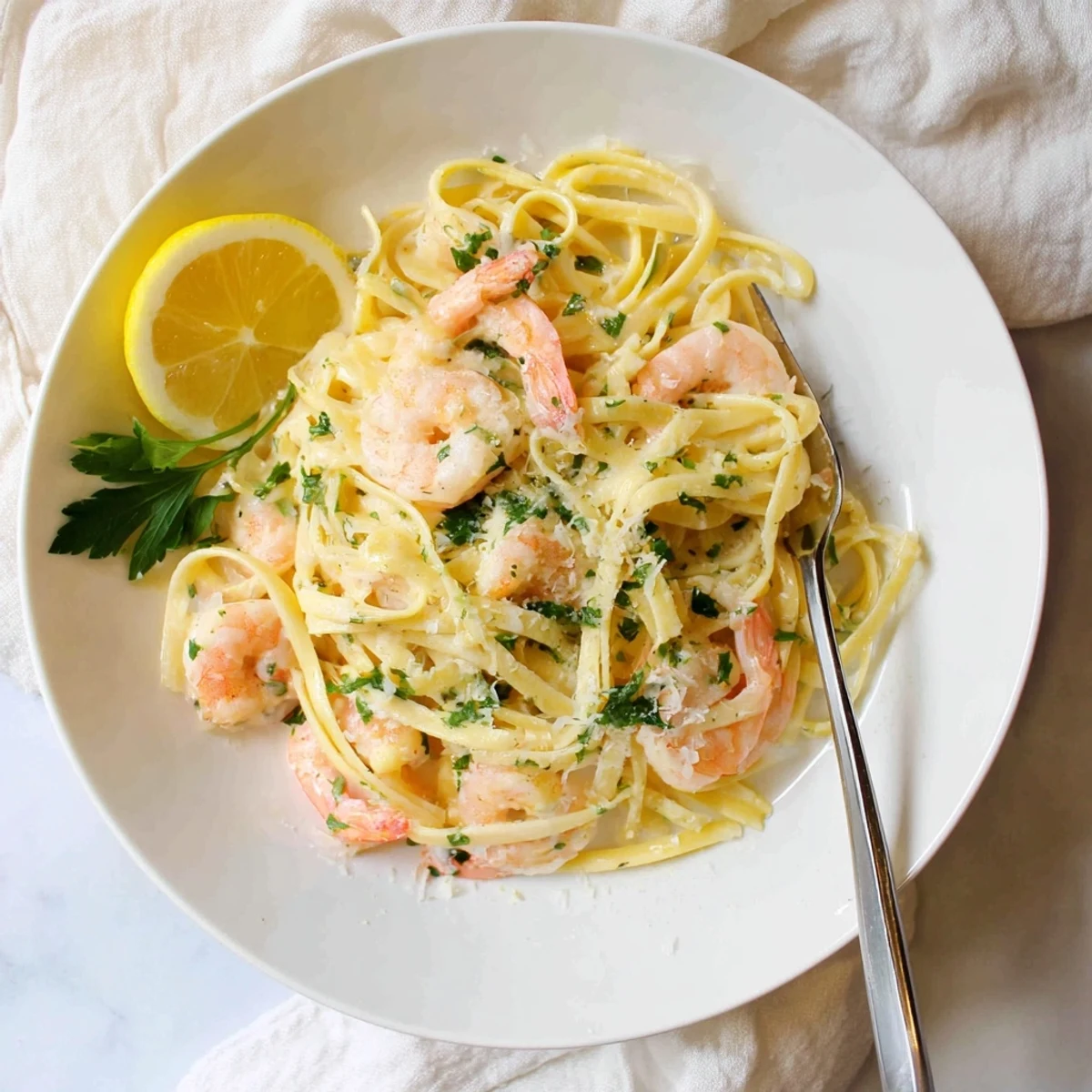 Plump shrimp and al dente pasta coated in velvety garlic cream sauce with lemon zest