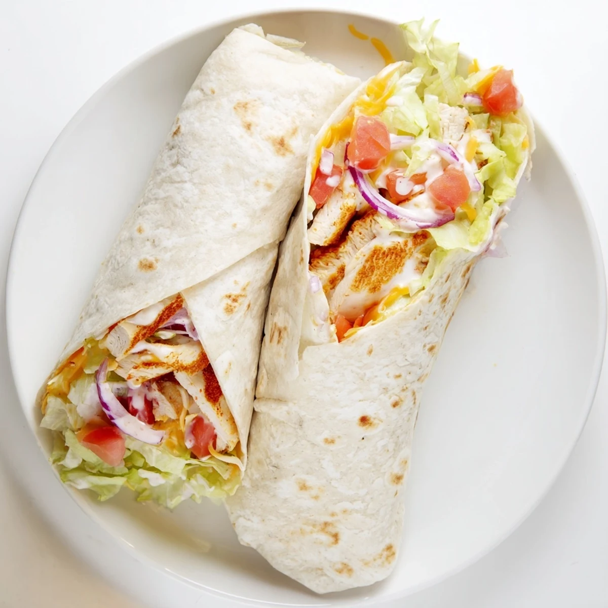 Warm flour tortilla rolled around seasoned chicken breast strips with zesty garlic sauce and shredded red onions