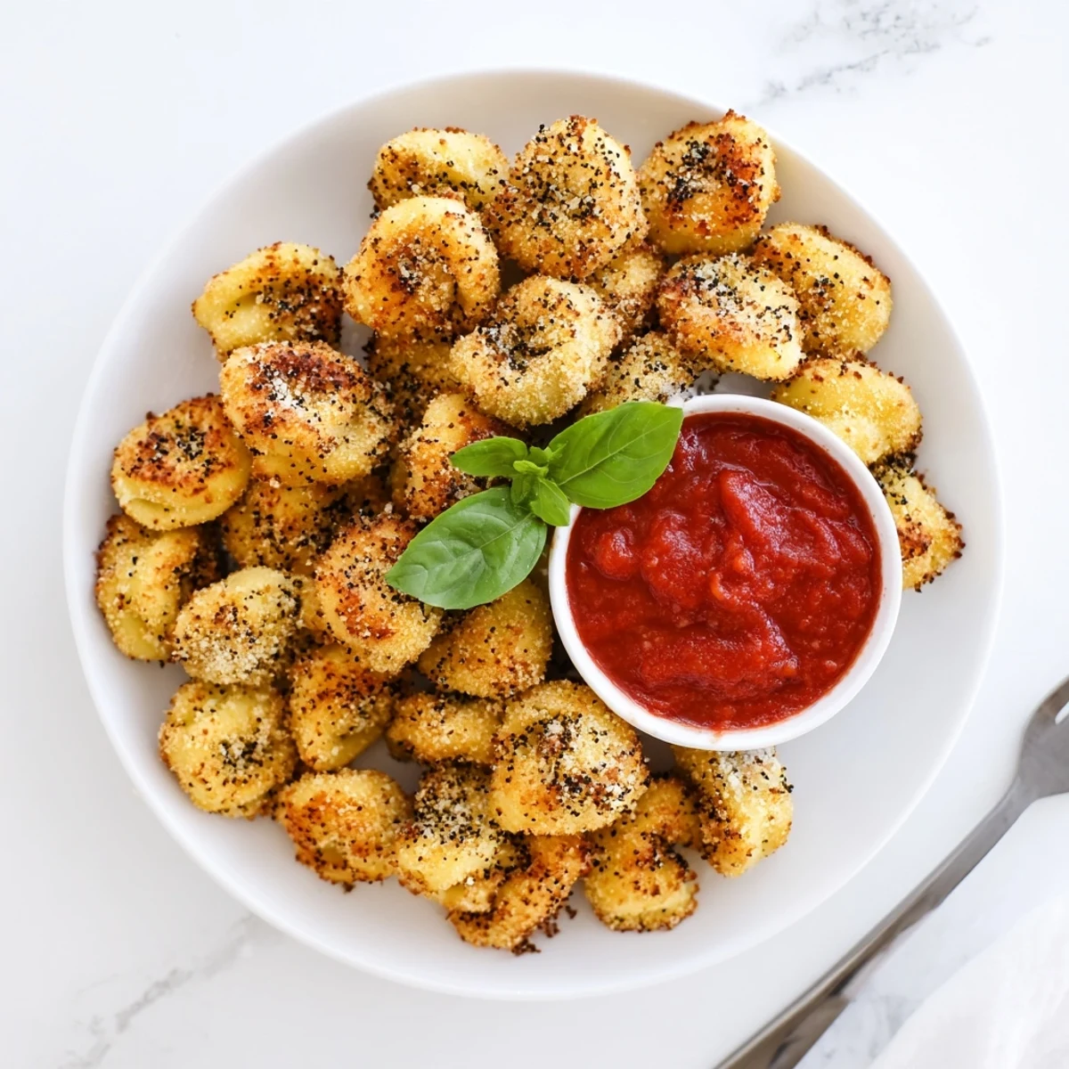 Italian appetizer of parmesan crusted air fryer tortellini perfectly golden and ready for dipping