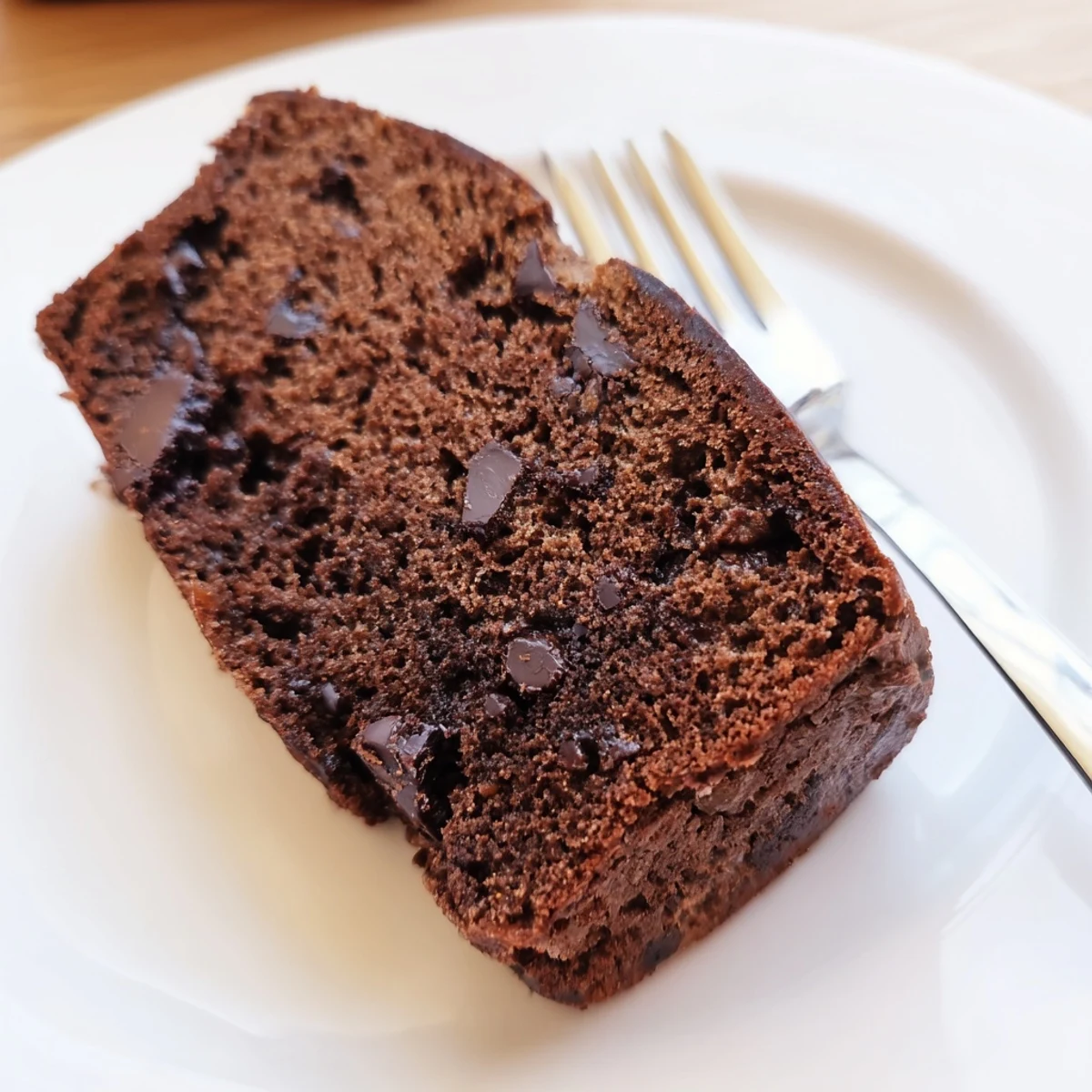 Thick slice of chocolate espresso banana bread topped with melted chocolate chips
