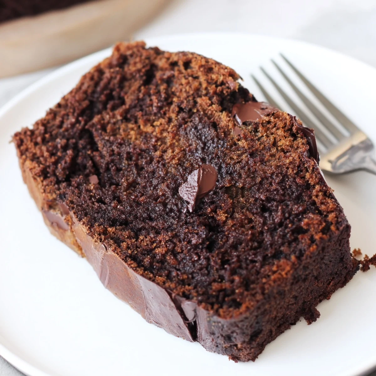Rich cocoa infused banana bread with espresso and chocolate chips on wooden board