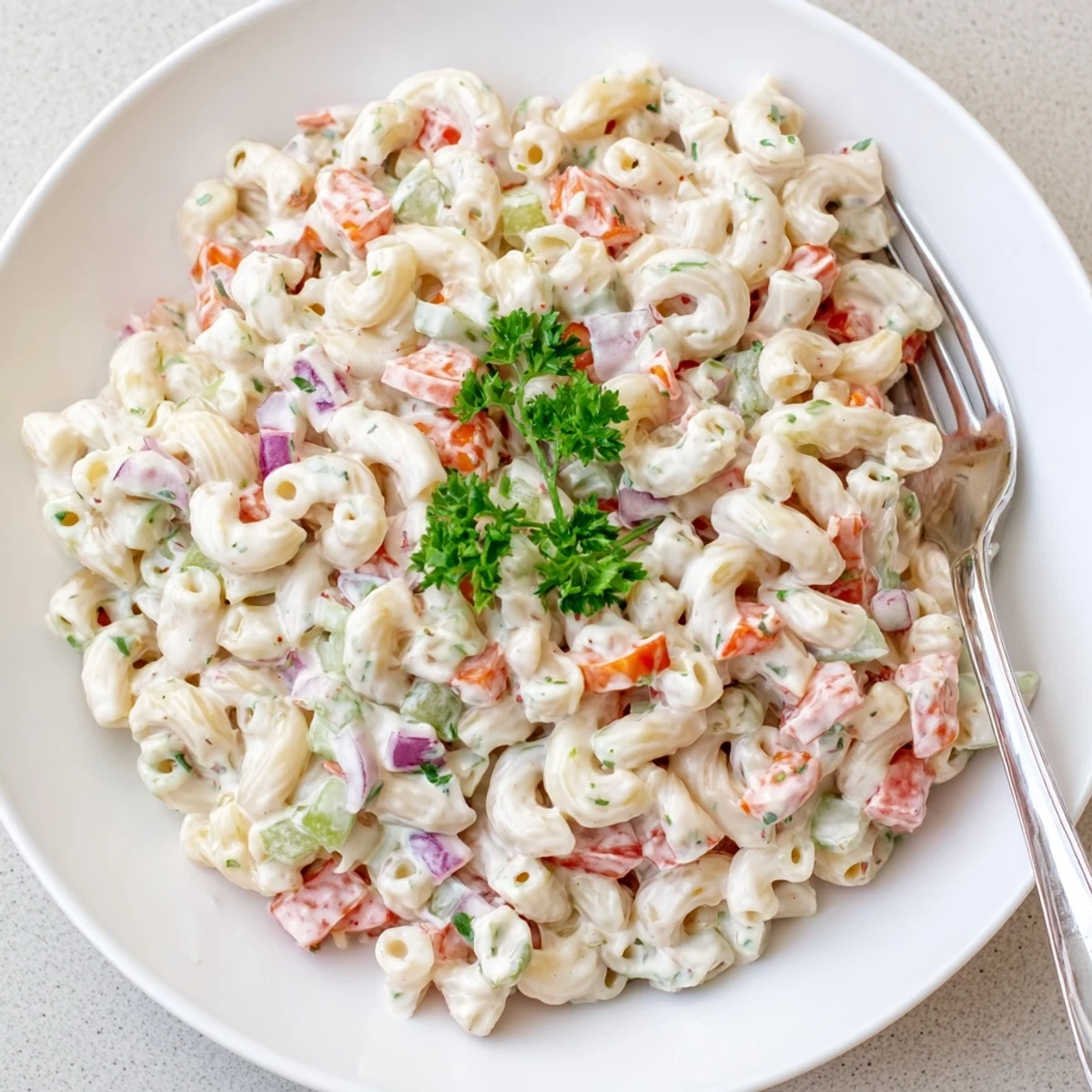 Classic American macaroni salad featuring tender pasta coated in rich mayonnaise dressing with crunchy peppers