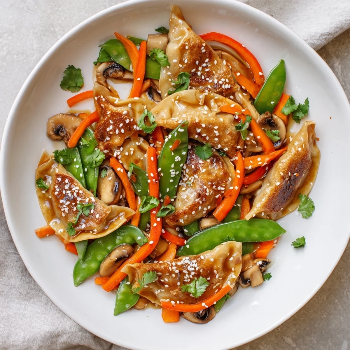 Crispy potstickers tossed with snap peas and bell peppers in glossy stir fry