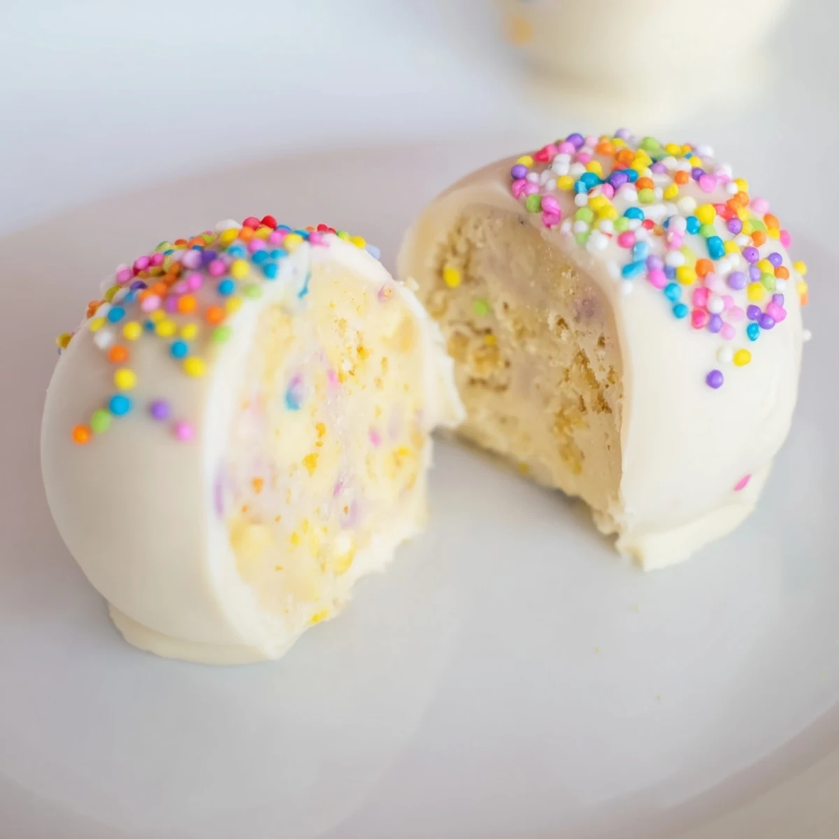 Golden vanilla wafer studded banana pudding truffles drizzled with smooth melted white chocolate coating