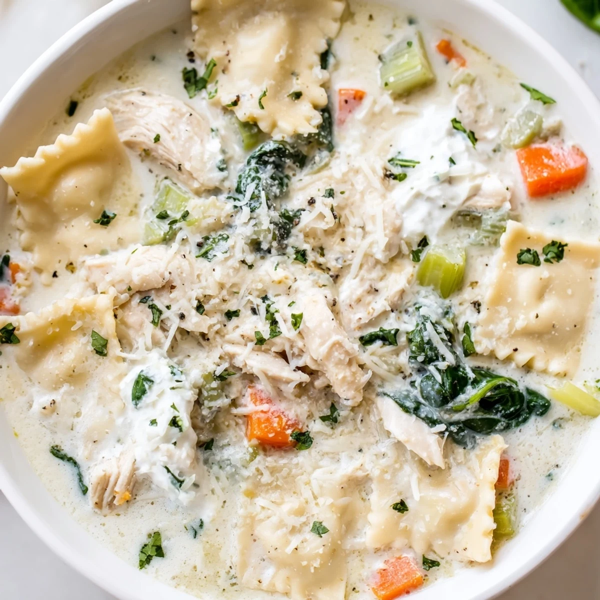 Creamy Italian white lasagna soup topped with melted mozzarella and fresh parsley