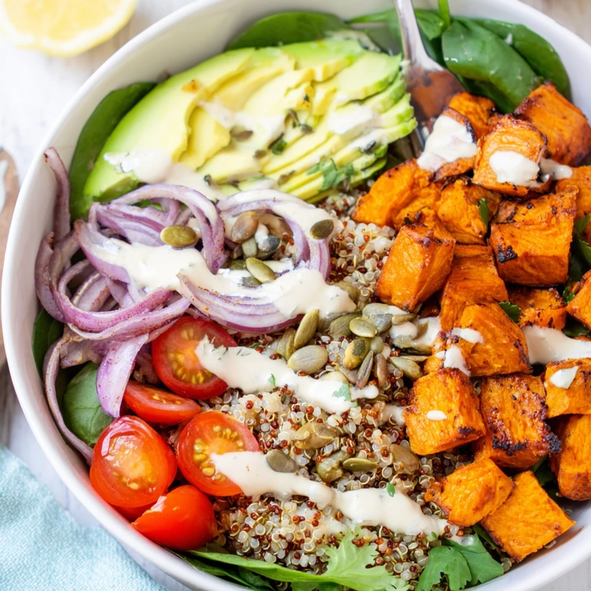 Roasted Sweet Potato Quinoa Salad Bowl with golden roasted cubes, lemon-tahini drizzle