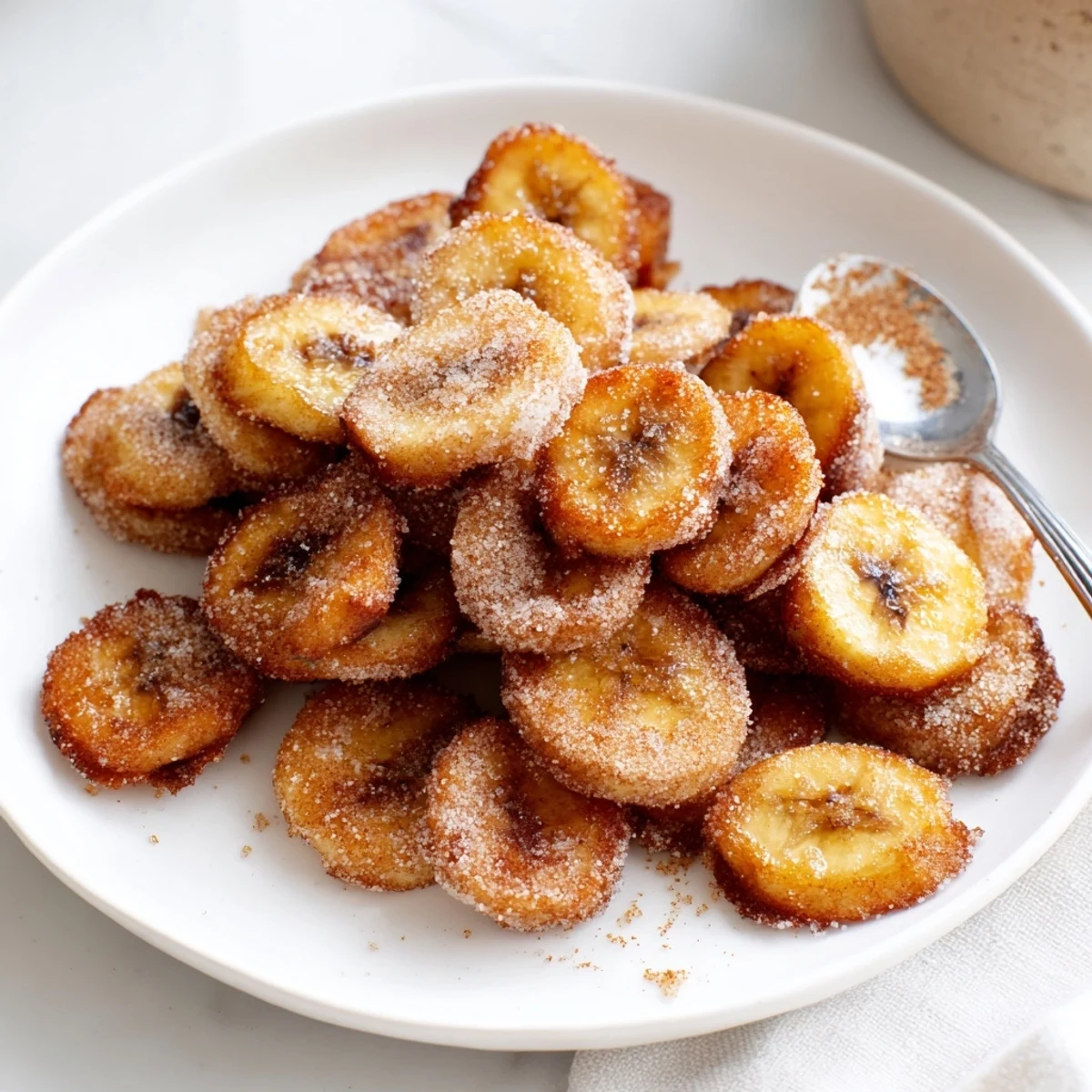Freshly made Crispy Cinnamon Sugar Air Fryer Banana Chips cooling, cinnamon-scented crunch