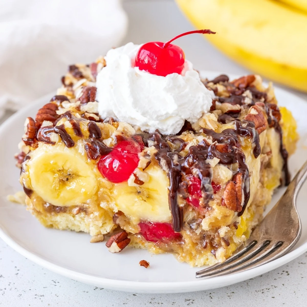 Warm Banana Split Dump Cake with bubbling edges, glistening cherries, melty chocolate.