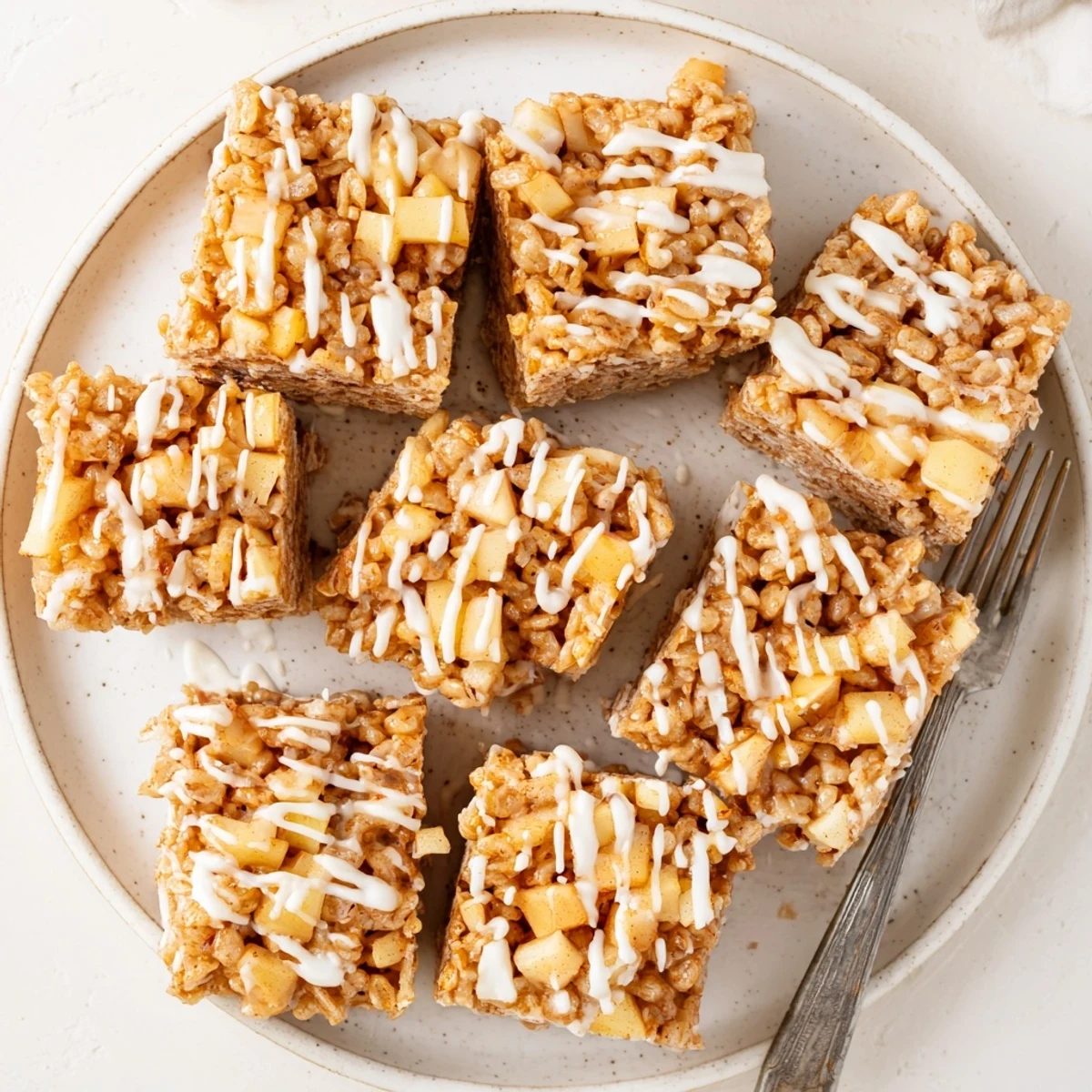 Chewy marshmallow Rice Krispie bars studded with warm cinnamon-spiced caramelized apple pieces