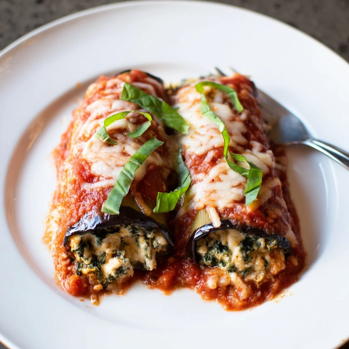 Oven-roasted Healthy Eggplant Rollatini with creamy ricotta and spinach filling, golden edges
