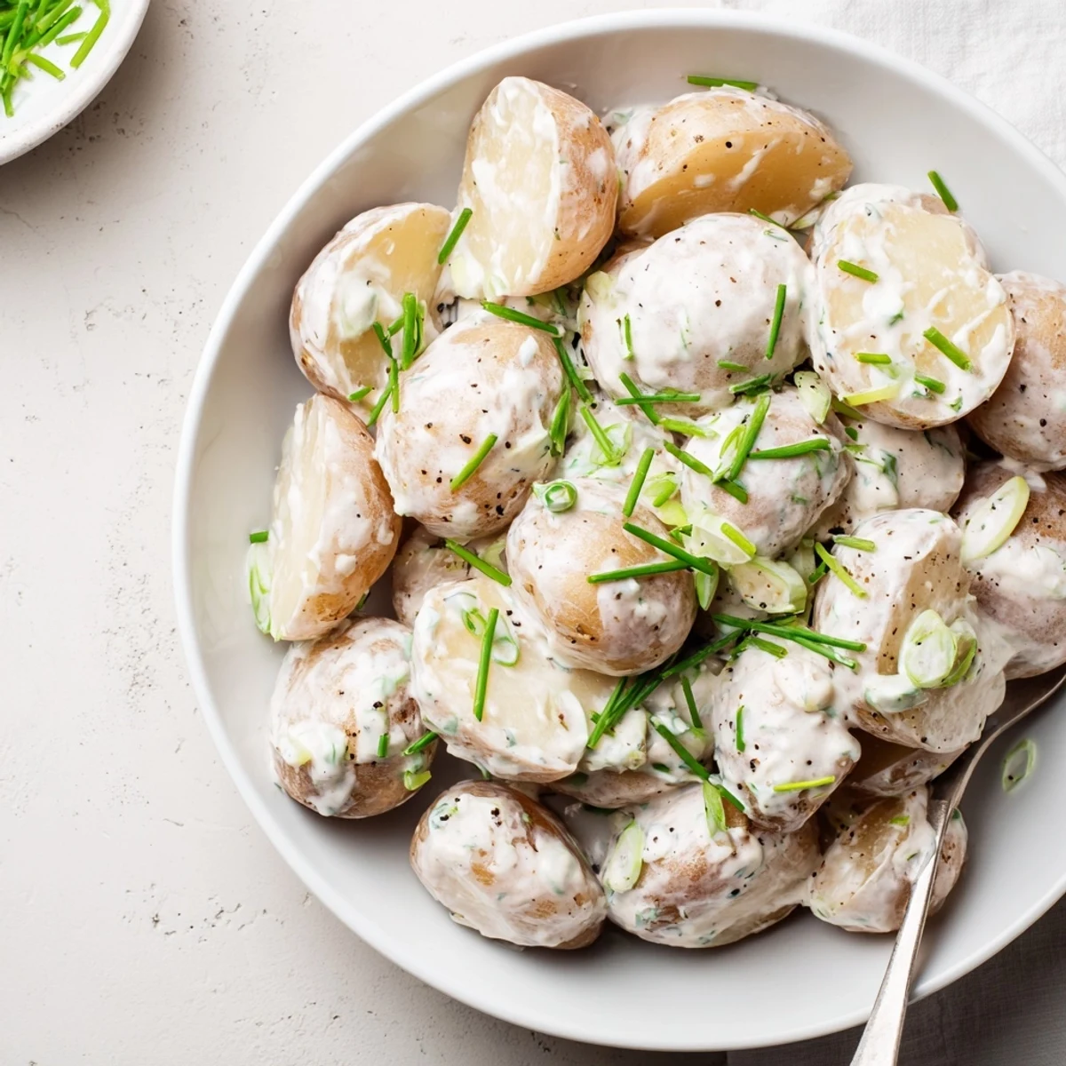 Sour Cream And Onion Potato Salad forkful showing tender potatoes, cool tang