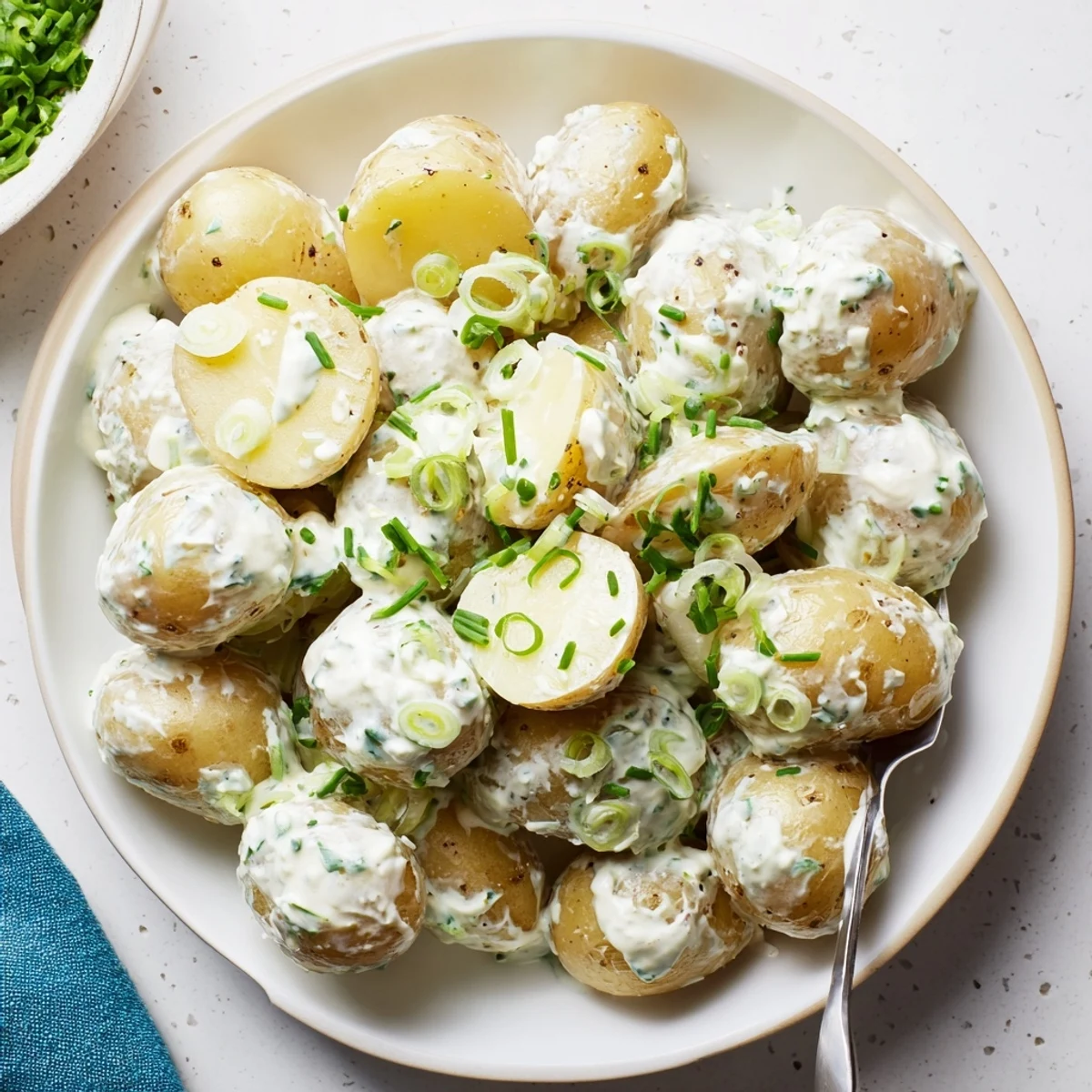 Picnic-ready Sour Cream And Onion Potato Salad chilled, scented with scallions and chives  
