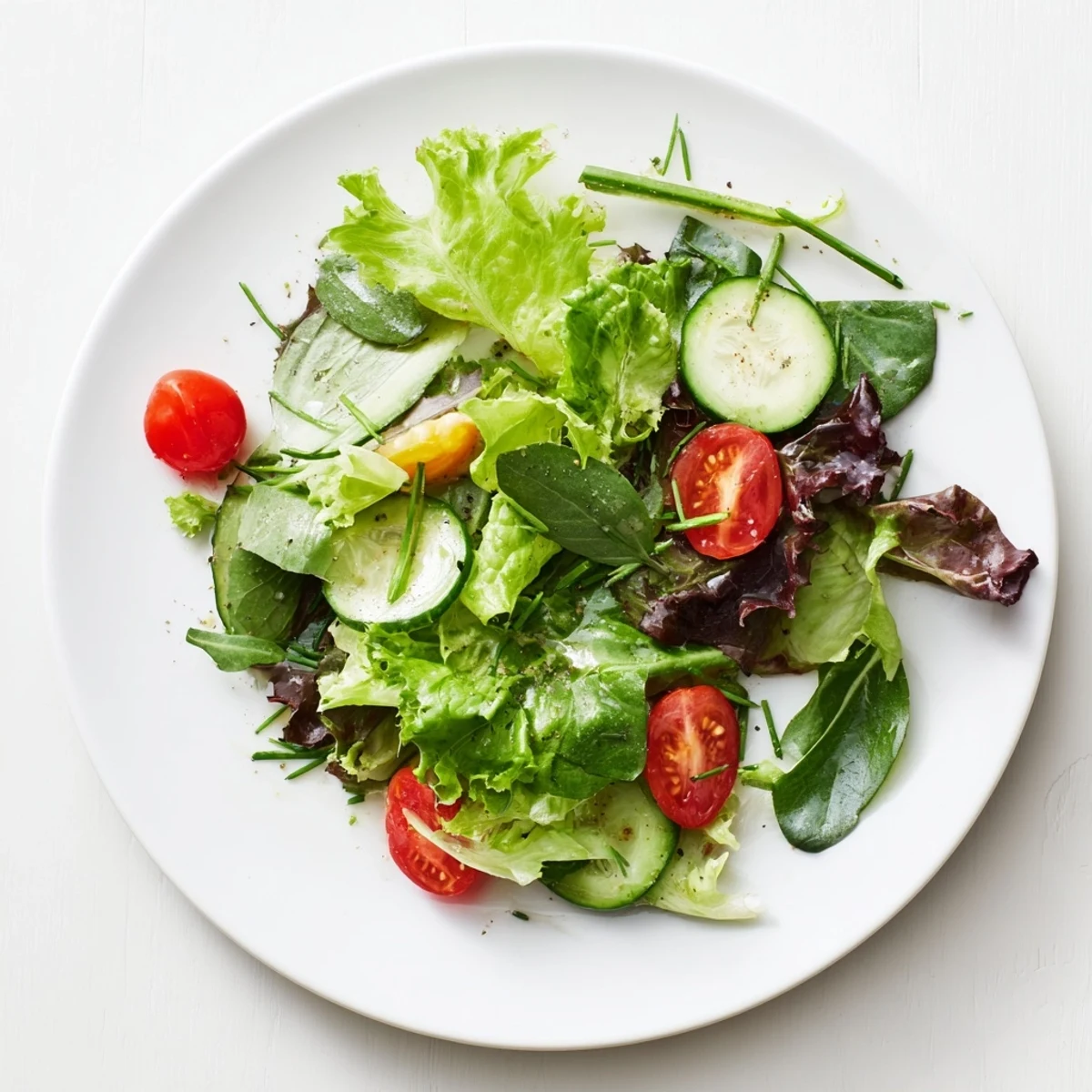 Simple green salad recipe with crisp mixed greens, tangy lemon vinaigrette drizzle