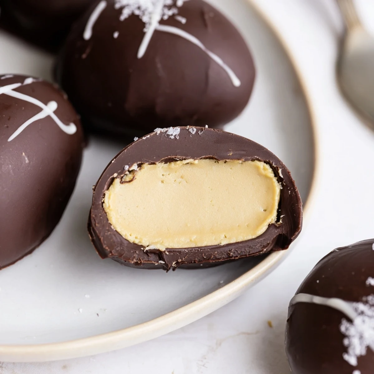 Homemade Peanut Butter Eggs with glossy chocolate coating, chilled and ready to serve