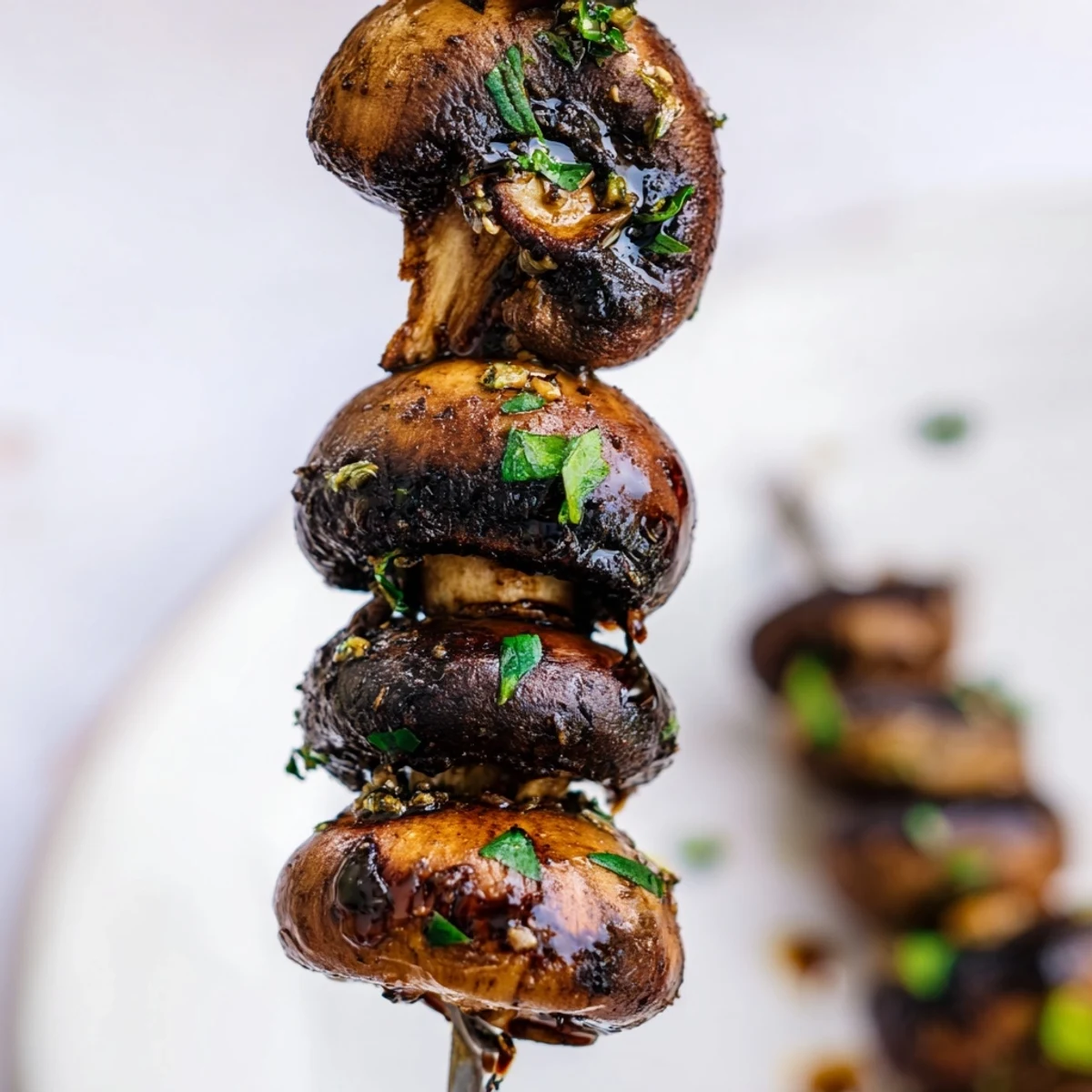 Balsamic Garlic Grilled Mushroom Skewers glistening with char, served warm with parsley