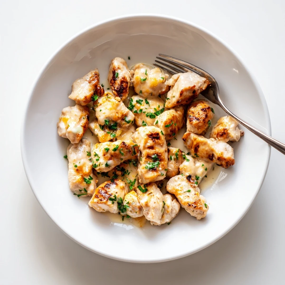 Grilled Chicken Bites With Creamy Garlic Sauce on skewers, smoky charred edges.