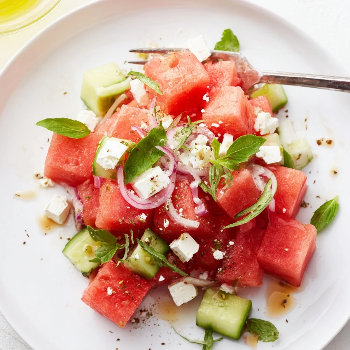 Colorful Watermelon Feta Salad Recipe showing sweet-salty cubes, basil, and mint garnish