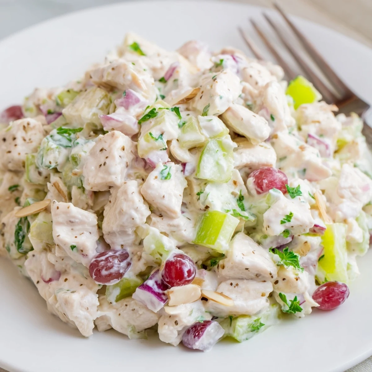 Healthy Greek Yogurt Chicken Salad Recipe chilled on greens, studded with grapes and almonds