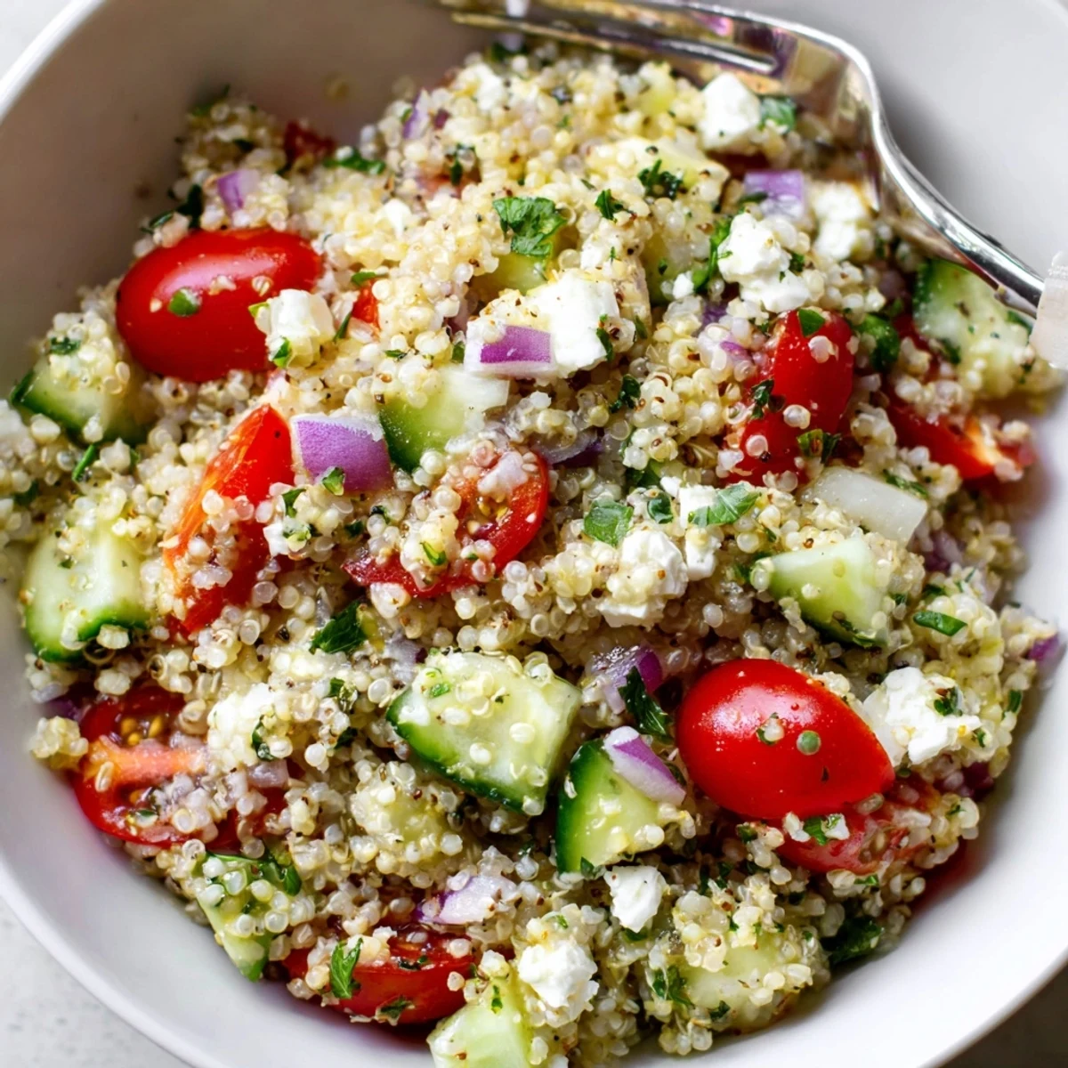 Chilled for lunch, Favorite Quinoa Salad Recipe bright with tomatoes and cucumber.