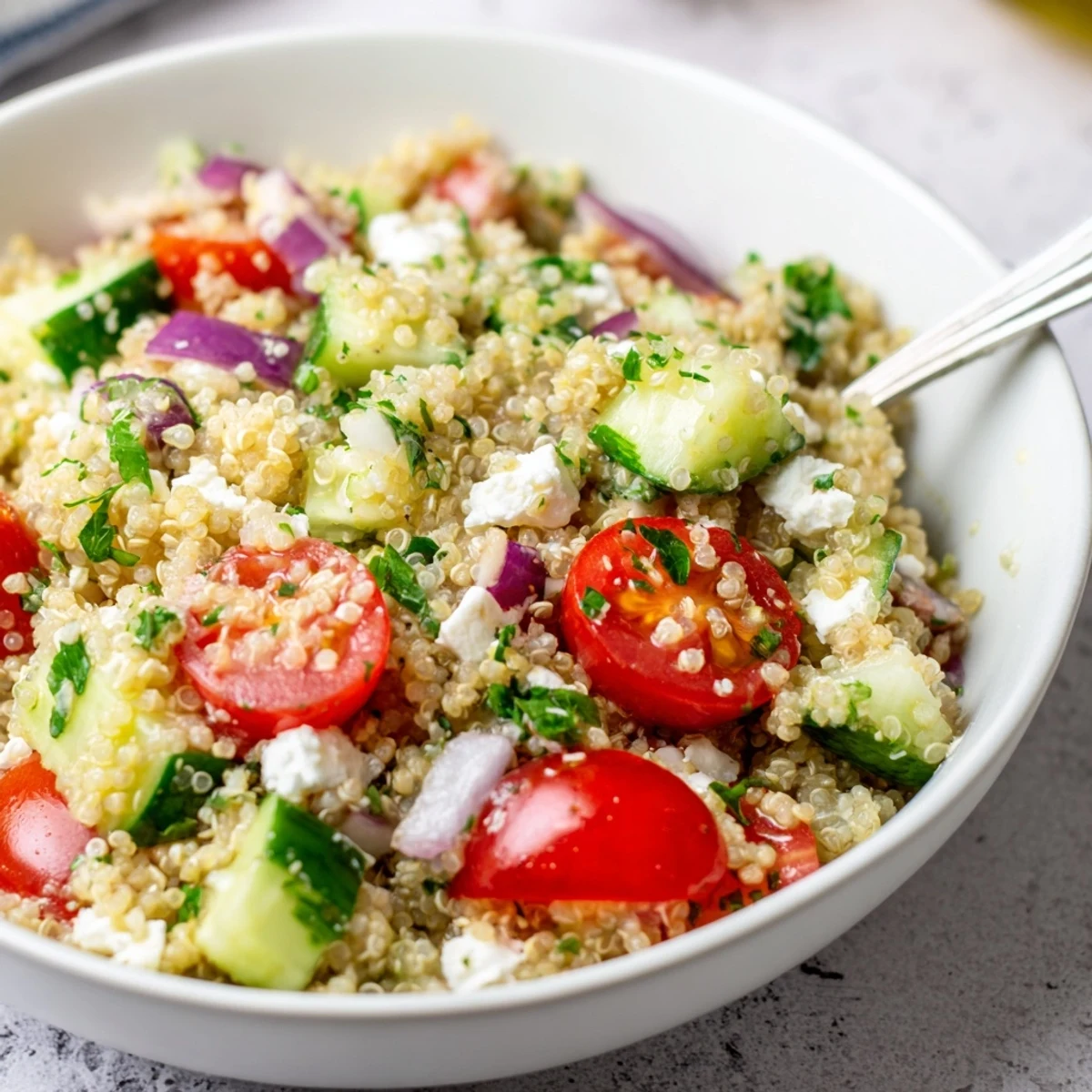 Heaping serving of Favorite Quinoa Salad Recipe tossed with feta, mint.